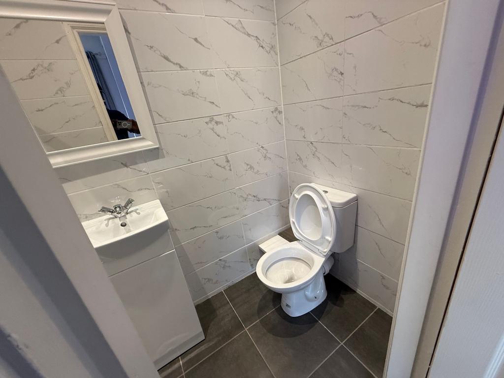 Bright, recently tiled WC with a modern toilet,...