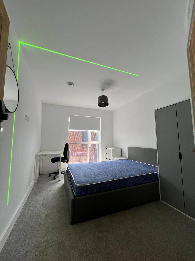 Bright, modern double bedroom with a comfortabl...
