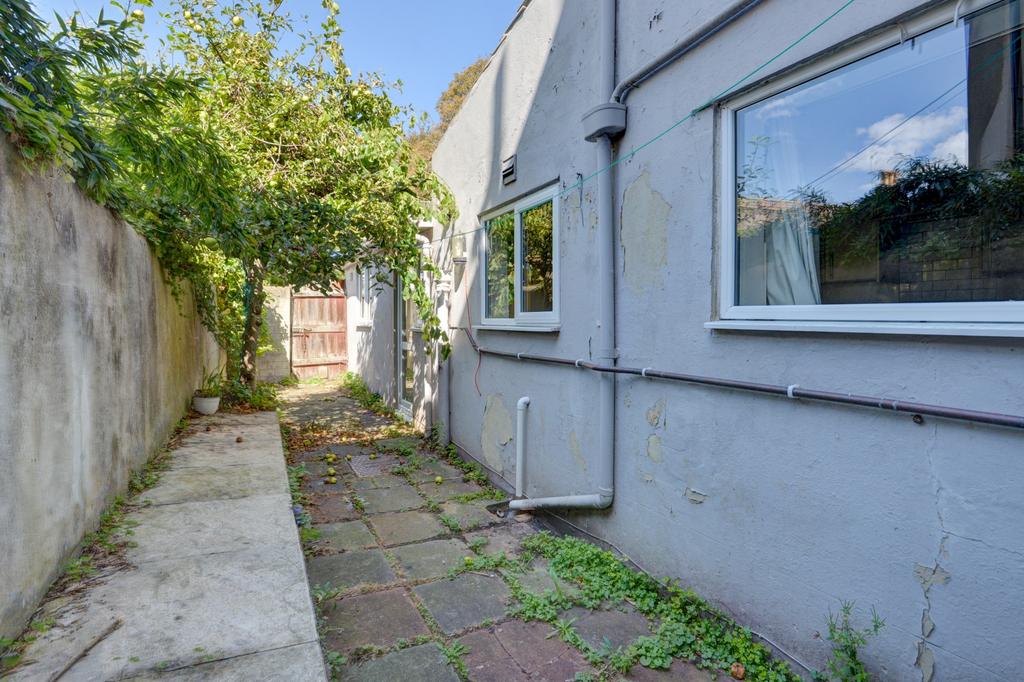 Private gated side passage with paved walkway, ...