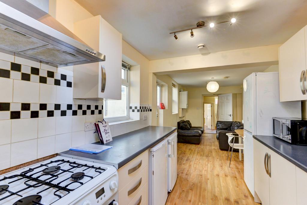 Bright galley kitchen with modern appliances, t...