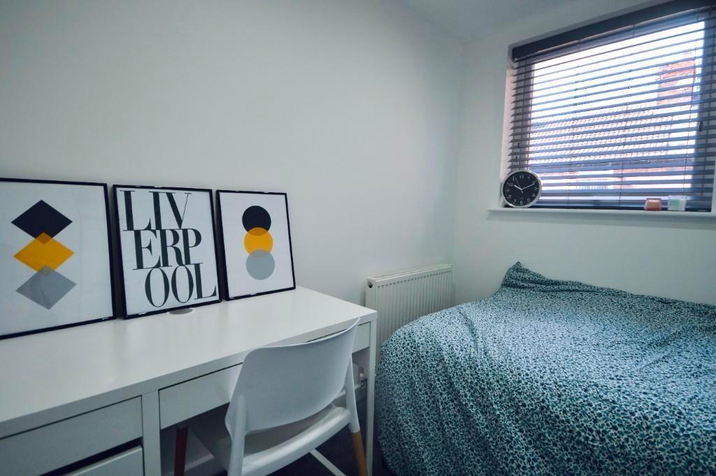 A neat and bright single bedroom featuring a co...