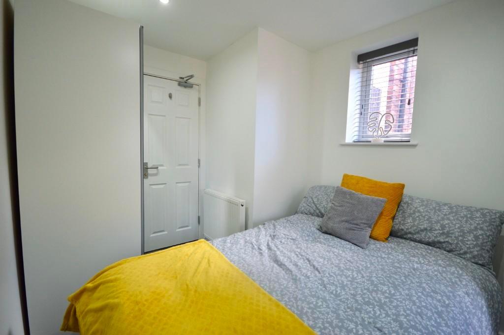 A bright and welcoming double bedroom with a co...