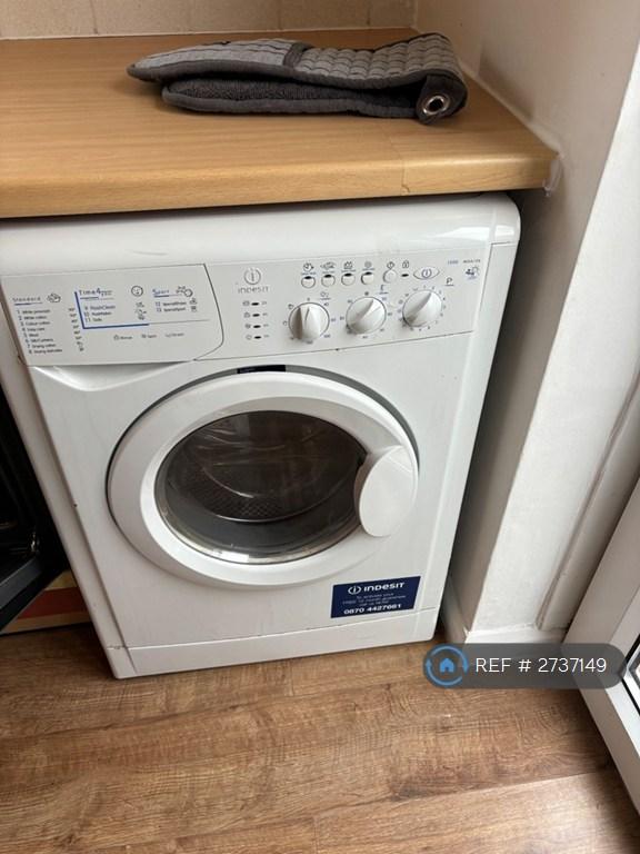 Kitchen Has Washing Machine And Clothes Dryer