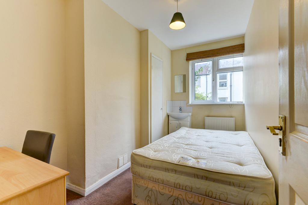 A comfortable double bedroom with a large windo...