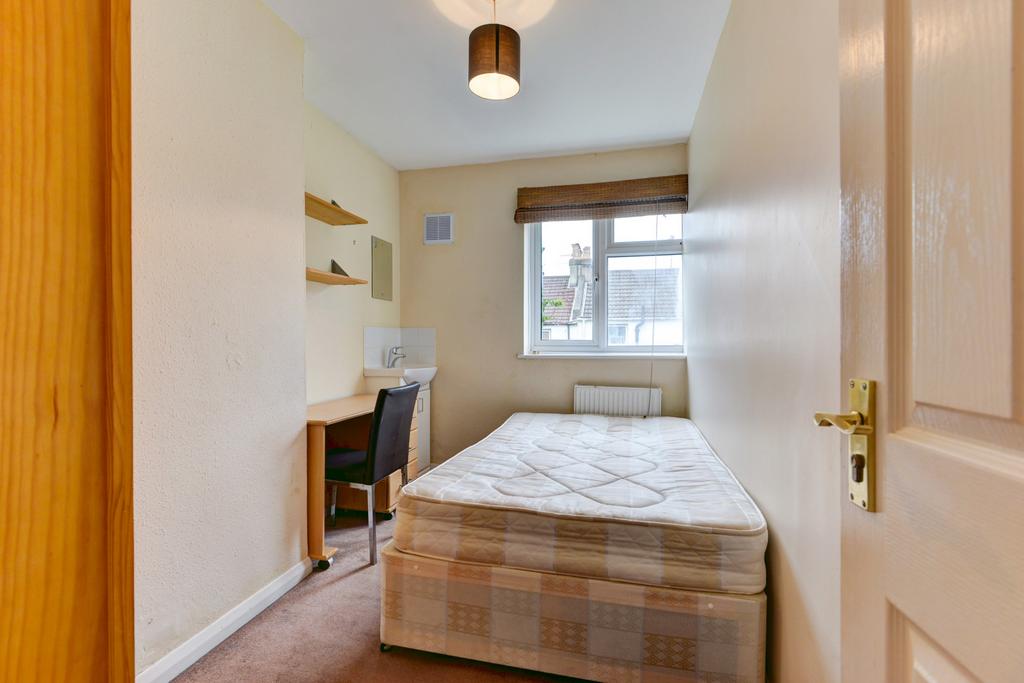 A tidy and cozy student bedroom featuring a spa...
