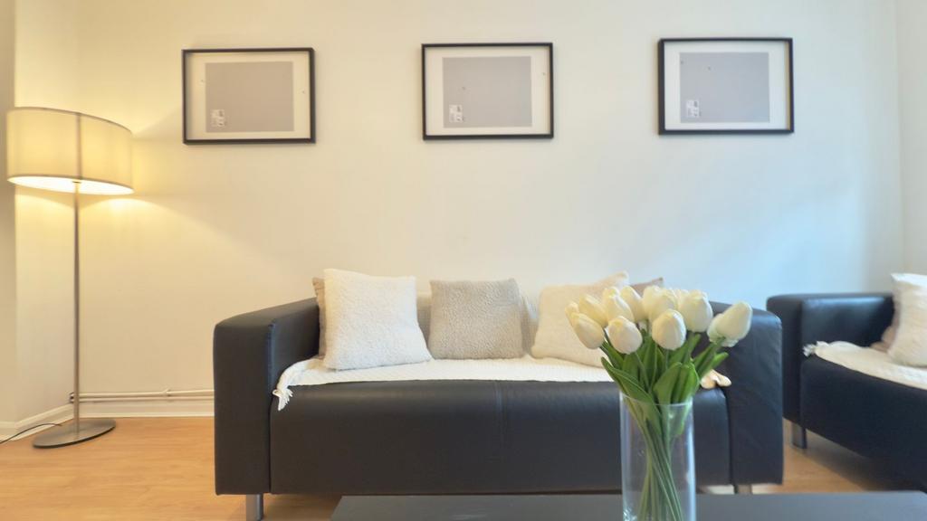 A bright, modern living room featuring a black ...