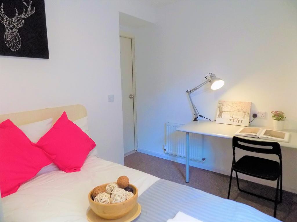 A neat and cozy bedroom featuring a single bed ...