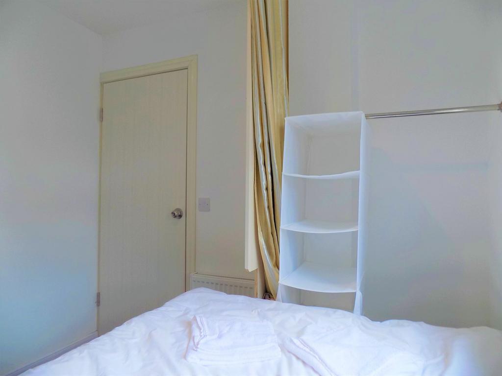 Bright and tidy single bedroom featuring a neat...