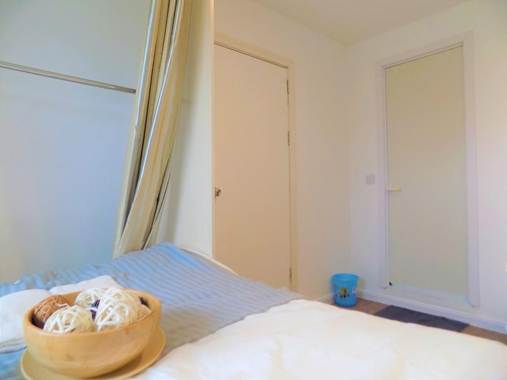A simple and clean single bedroom with neutral ...