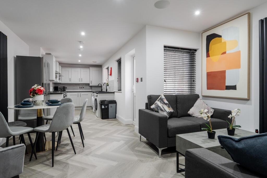 Modern and spacious living room featuring conte...