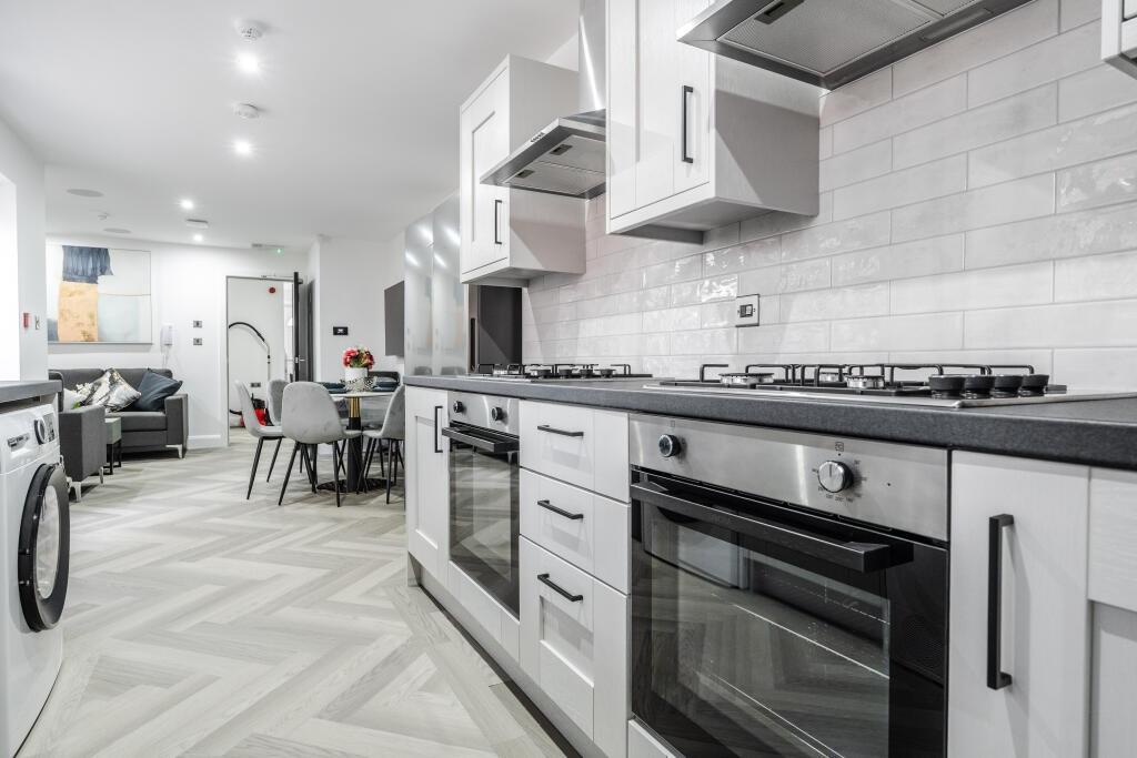 A modern, well-maintained kitchen featuring sle...