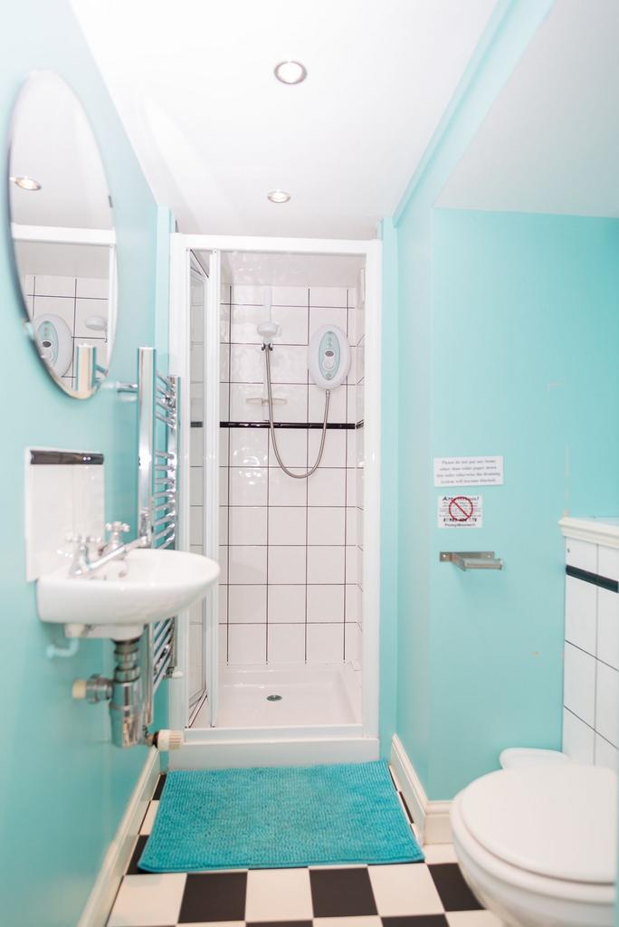 Bright, fresh bathroom with a modern tiled show...