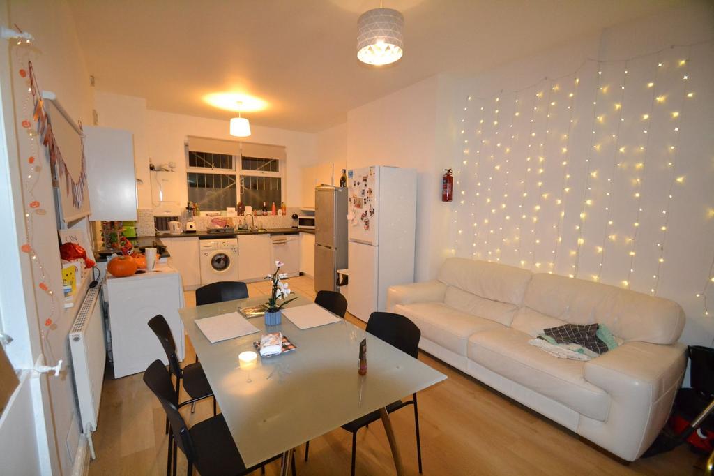 A cozy and well-lit living room featuring warm ...