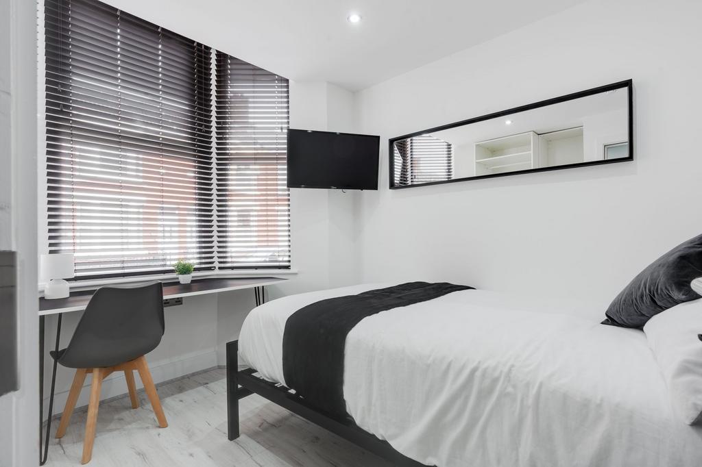 A bright and spacious master bedroom with large...