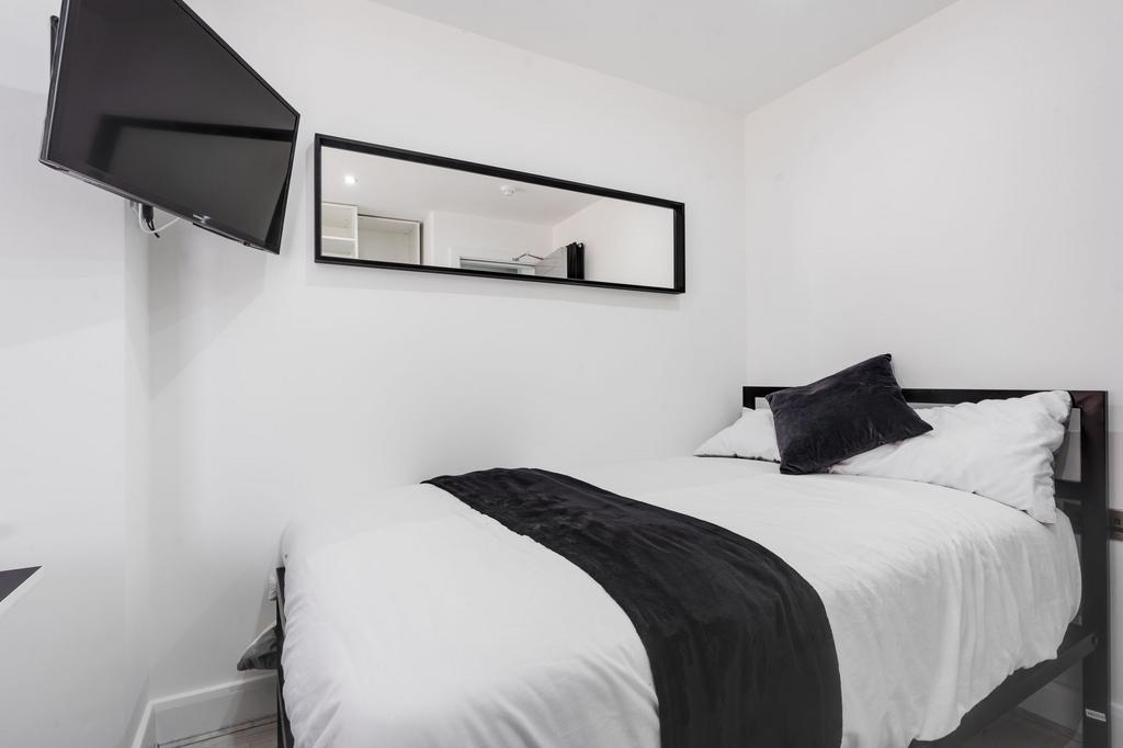 A modern and minimalist master bedroom featurin...