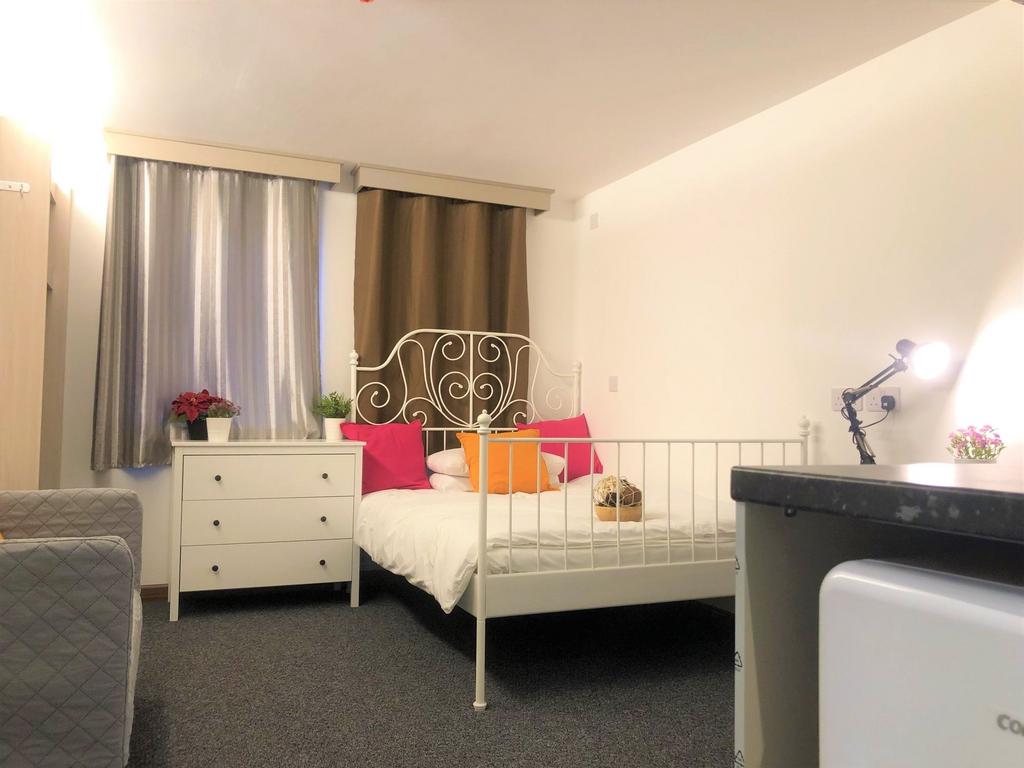 A cozy double bedroom with a decorative white m...