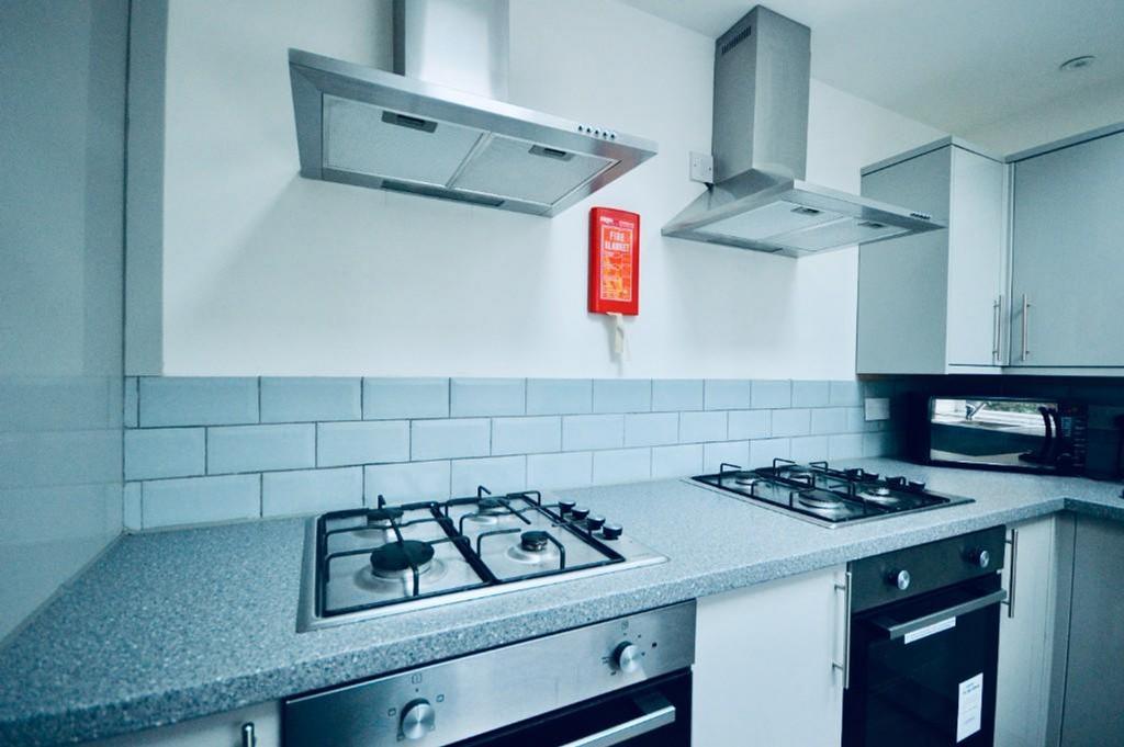 Modern kitchen featuring sleek countertops and ...