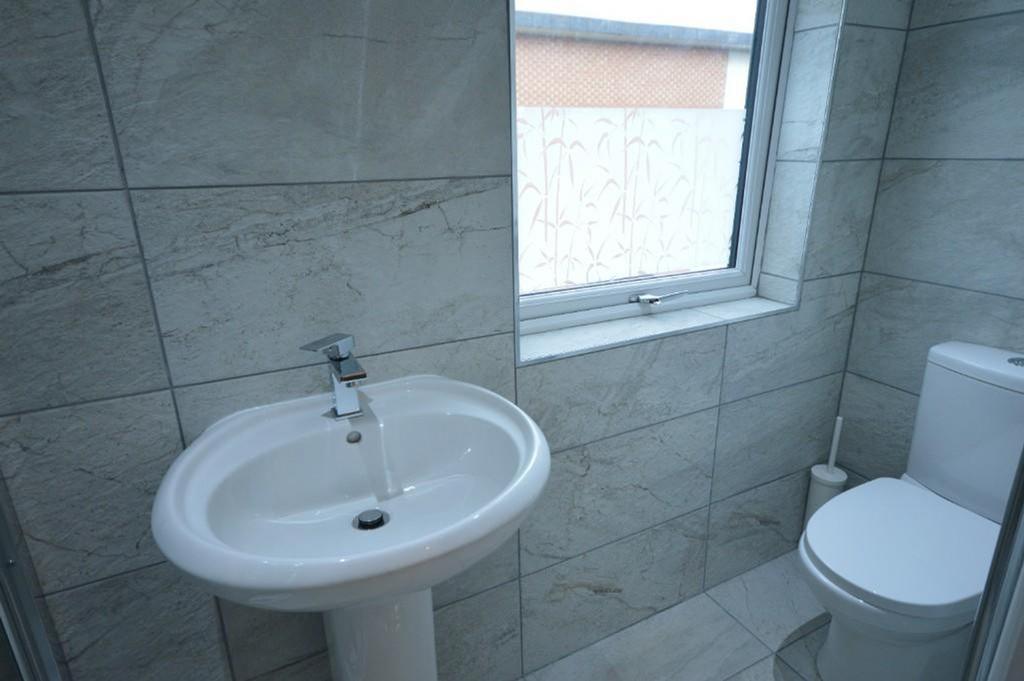 Modern bathroom featuring elegant tiles, a slee...