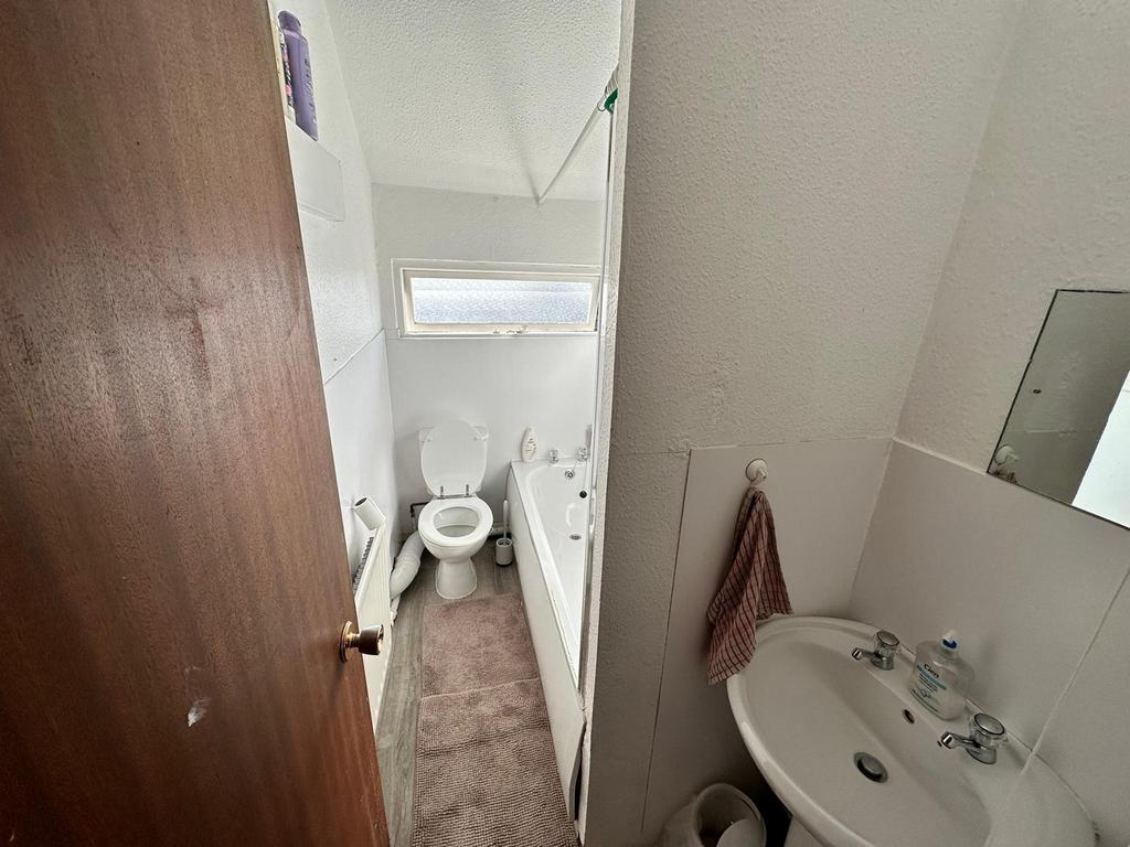 A well-maintained bathroom featuring a bath and...