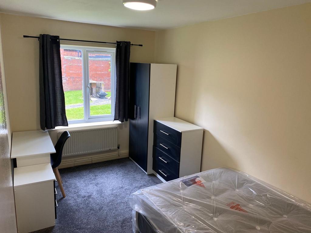 Bright and tidy single bedroom featuring a wind...