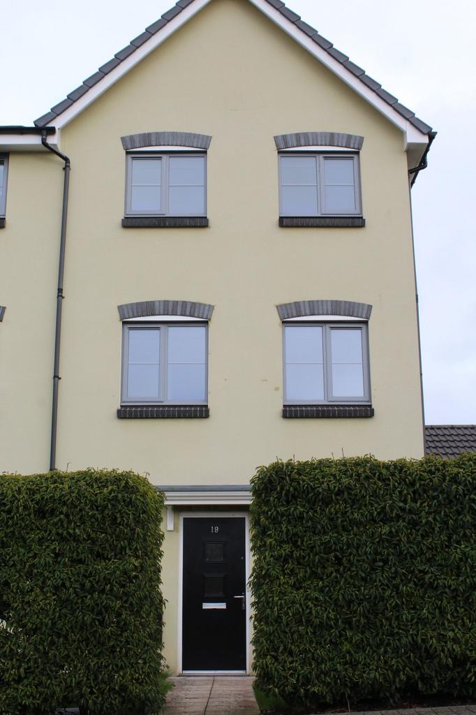 A welcoming front view of a modern, yellow resi...