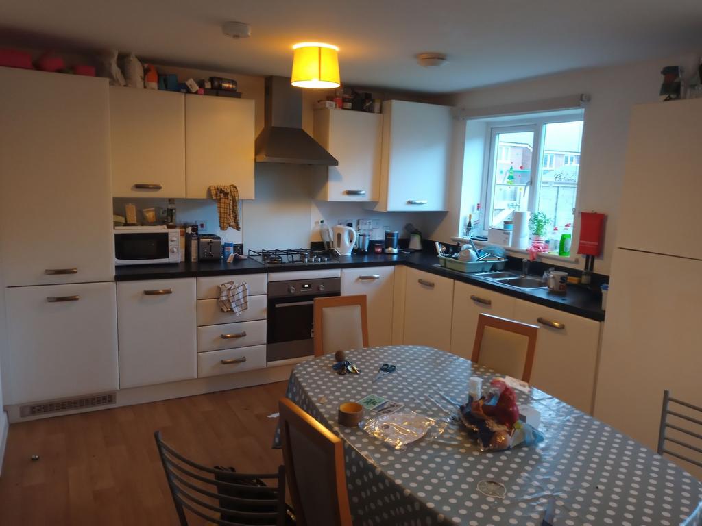 Bright modern kitchen with plenty of white cabi...