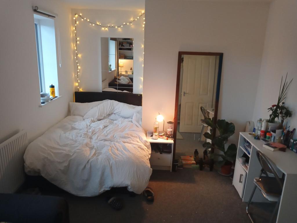 Cozy double bedroom with a comfy double bed, be...