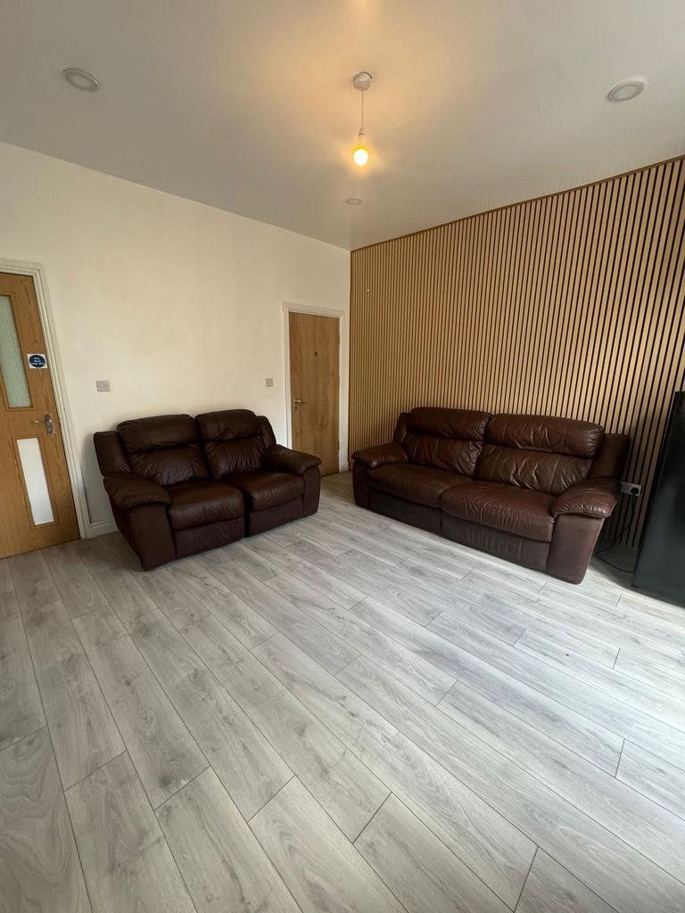 Bright, modern living room with light wood-effe...