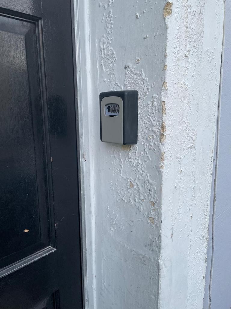 Exterior entryway showing a secure combination ...