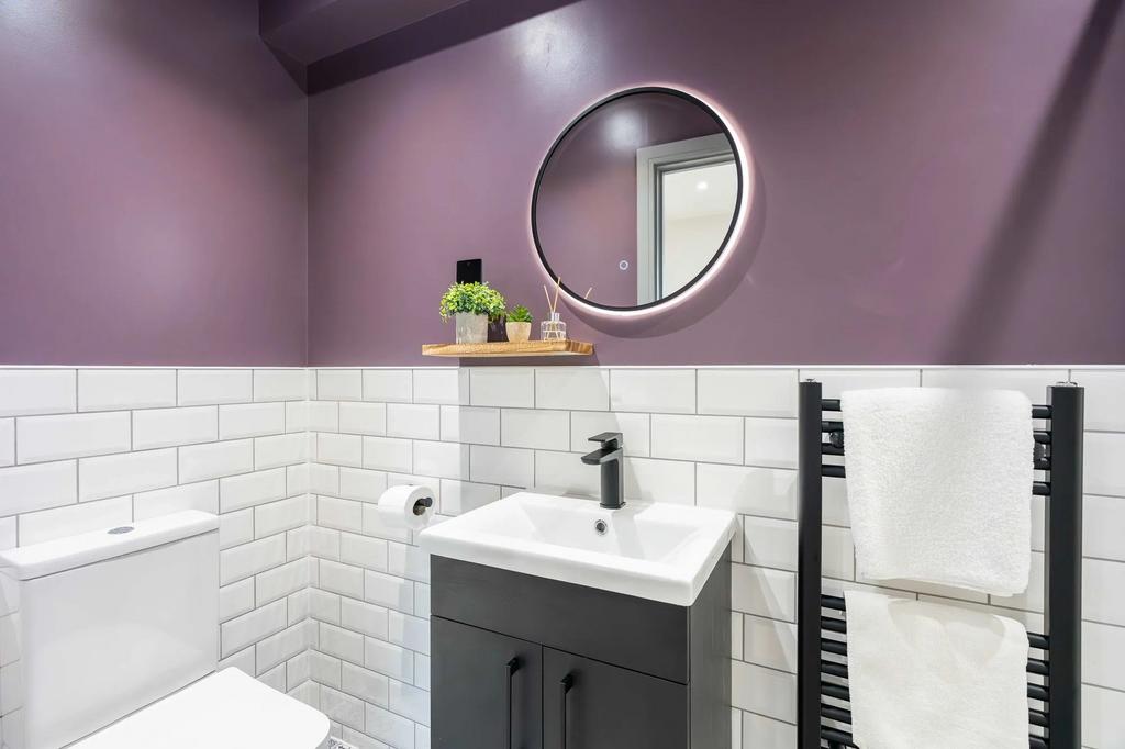 A modern and tidy bathroom featuring a sleek bl...