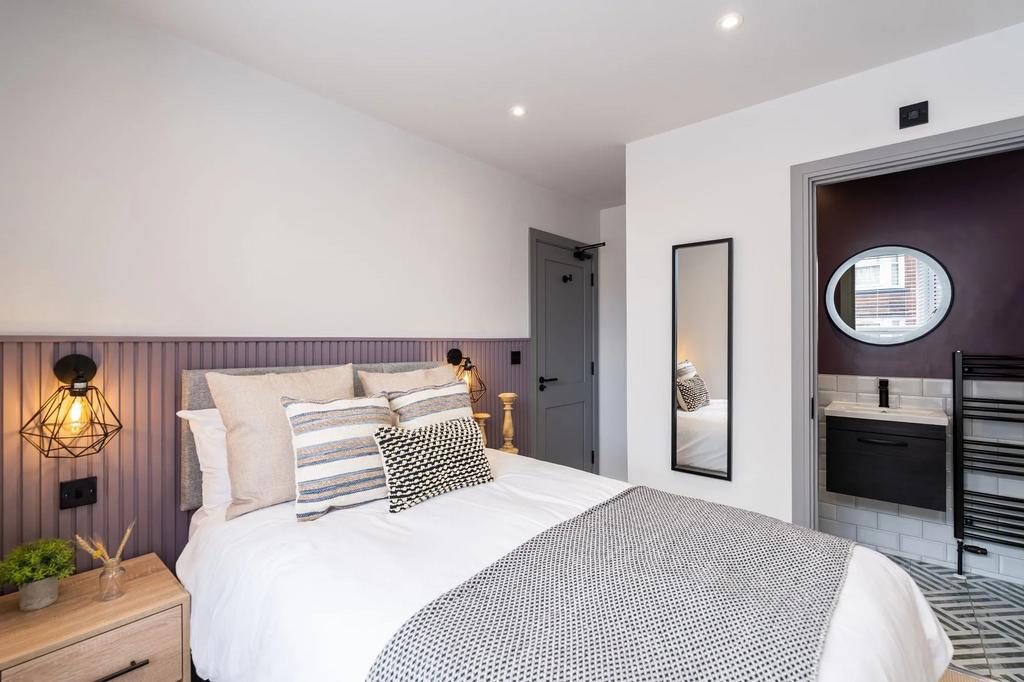 A modern and stylish bedroom with a comfortable...