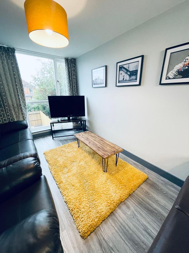 Bright, modern living room with large front win...