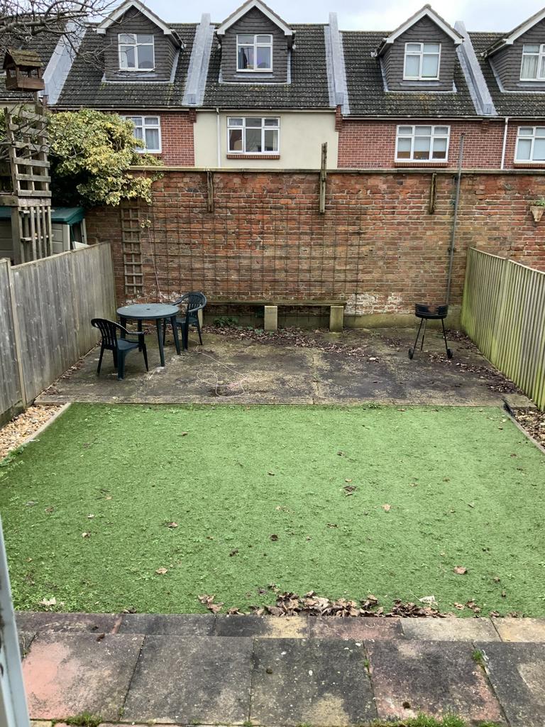 Private rear garden with artificial lawn and pa...