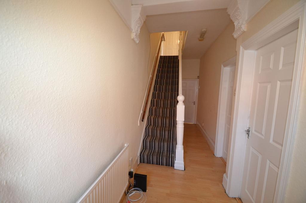 Bright, neutral hallway with wooden flooring, d...
