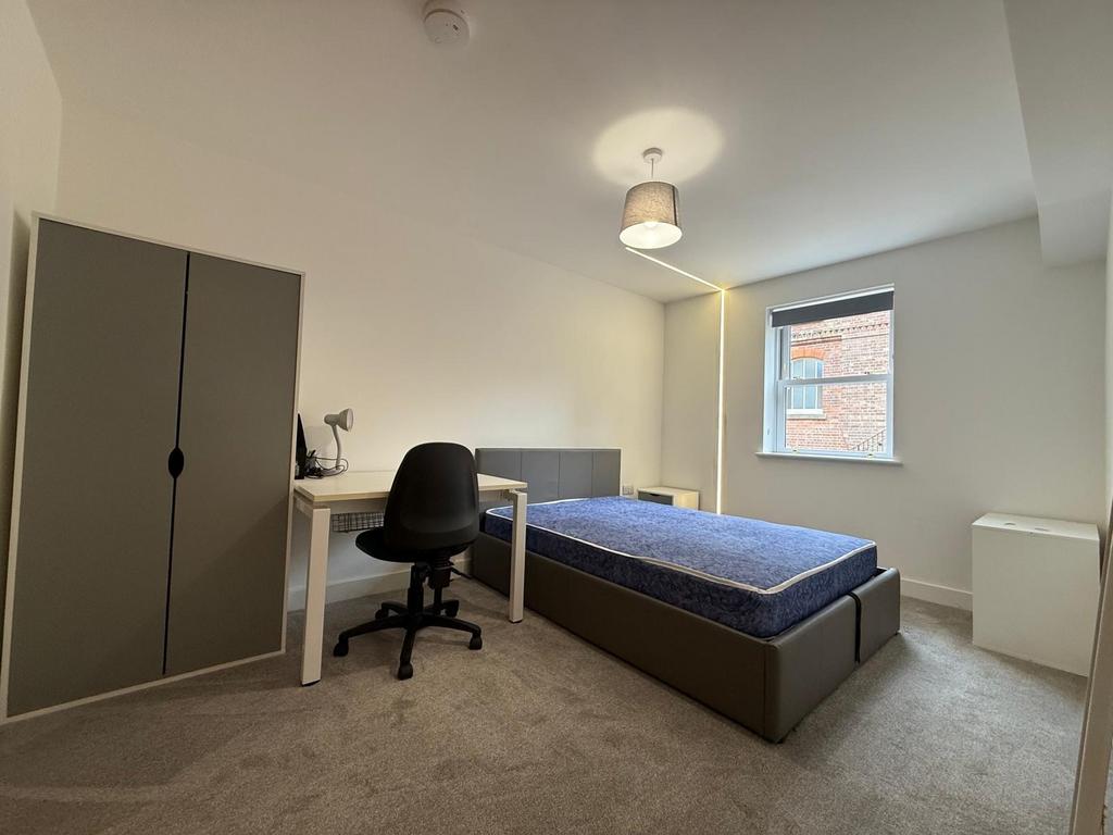 Bright, neutrally decorated bedroom with double...