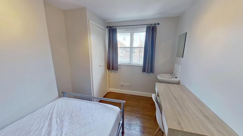 Bright and airy bedroom with a large window and...