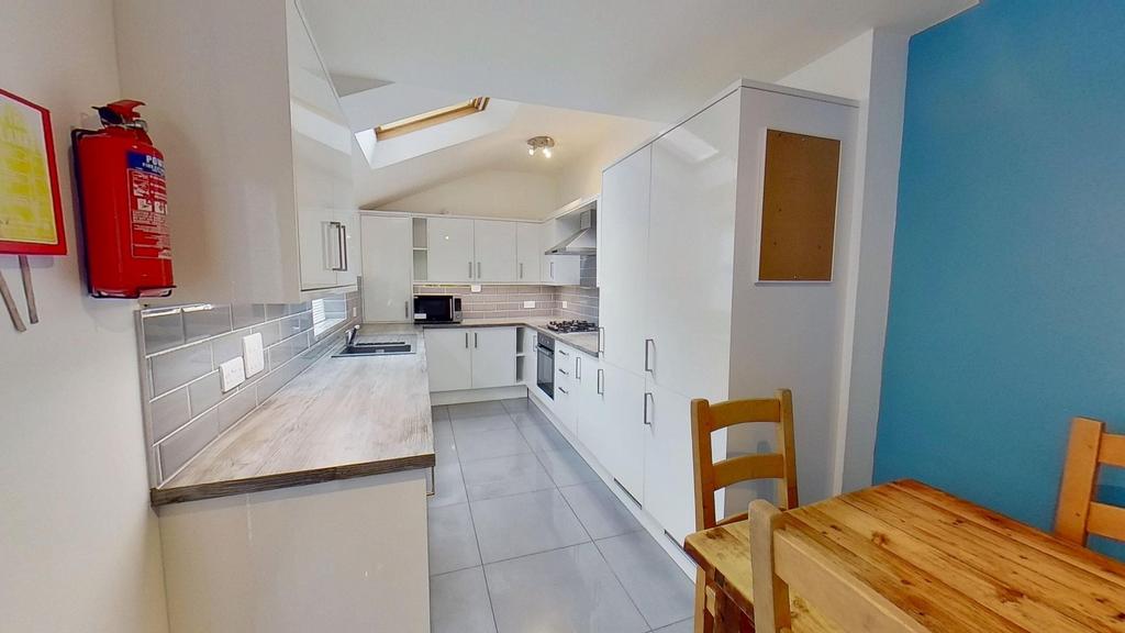 Bright and modern kitchen with white cabinetry,...
