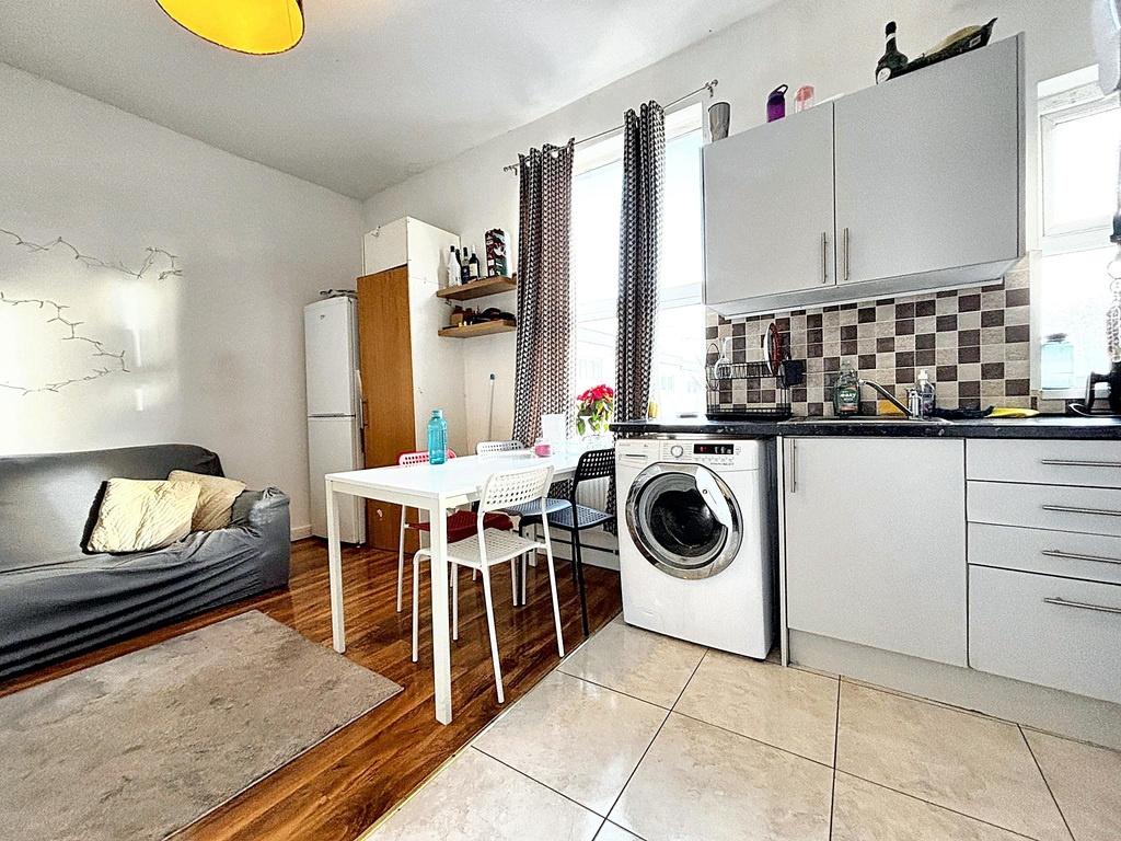 Bright, modern open-plan kitchen with tiled wor...