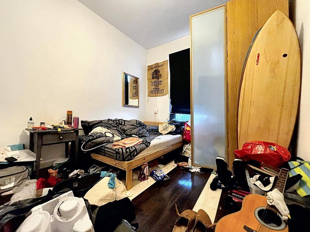 Cozy single bedroom with a raised bed, wardrobe...