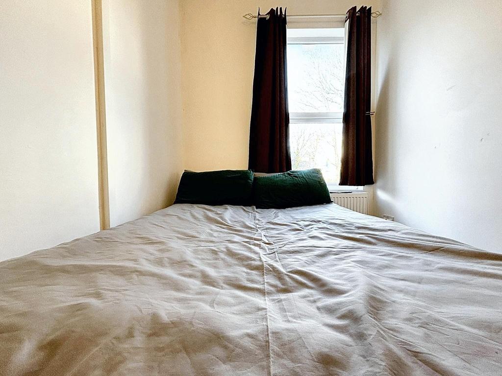 Bright, simply styled bedroom with a double bed...