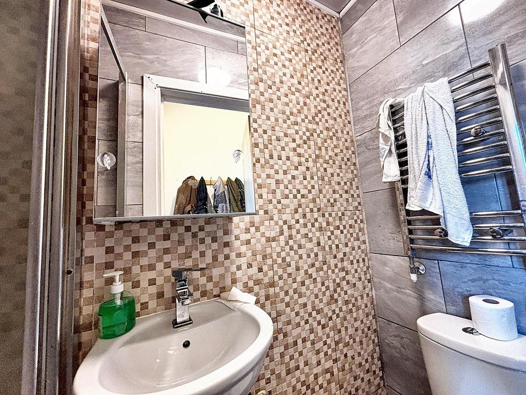 Modern bathroom with patterned tile accents, wa...