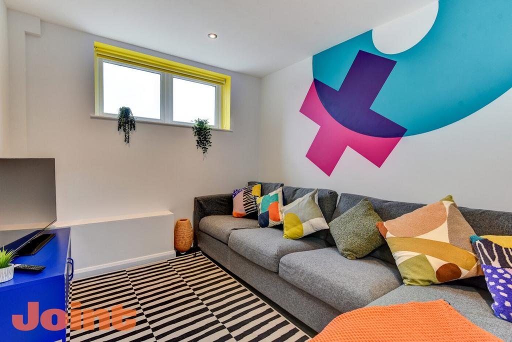 Modern and vibrant living room featuring a spac...
