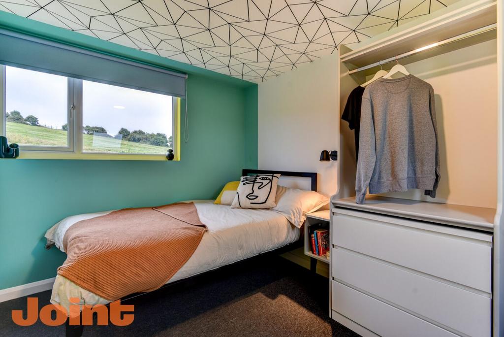 Bright and modern bedroom featuring a single be...