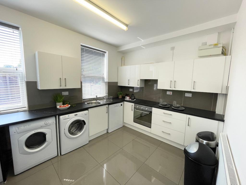 Bright modern kitchen with glossy floor tiles, ...