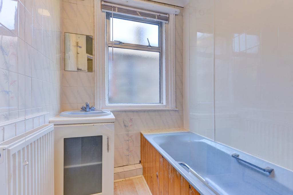 Bright, well-maintained bathroom featuring a ba...