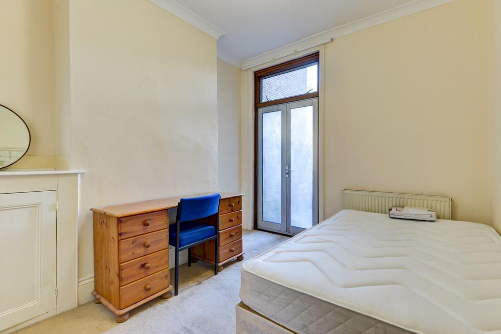 Bright, simply furnished bedroom with a comfort...