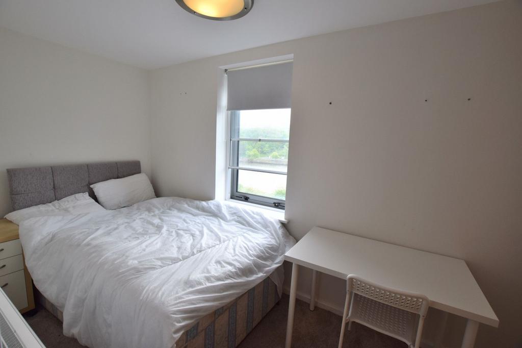 Bright and cozy double bedroom featuring a comf...