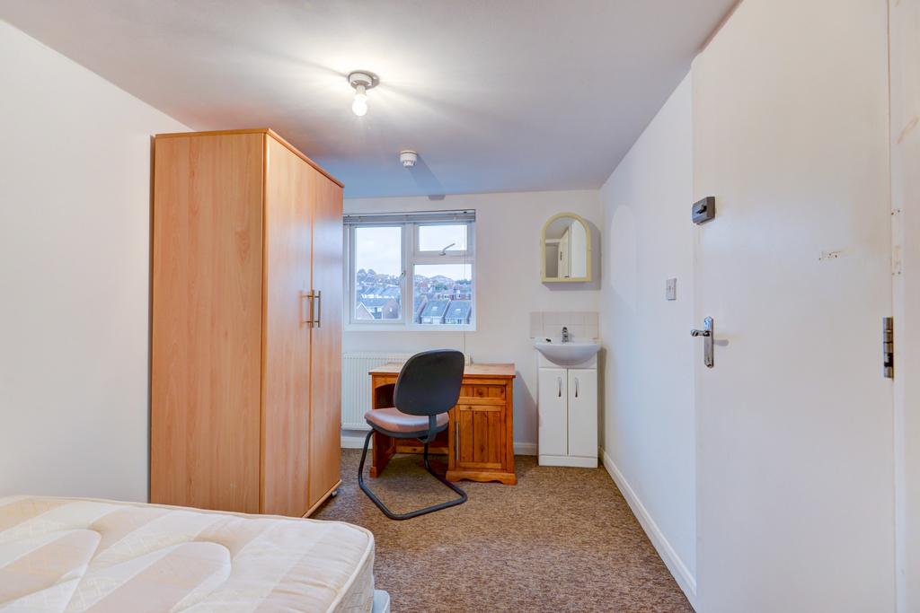 Compact bedroom with a comfortable single bed, ...