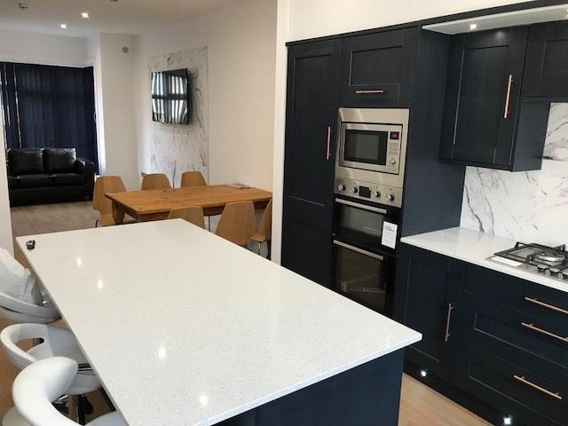 Modern, well-maintained kitchen with sleek dark...