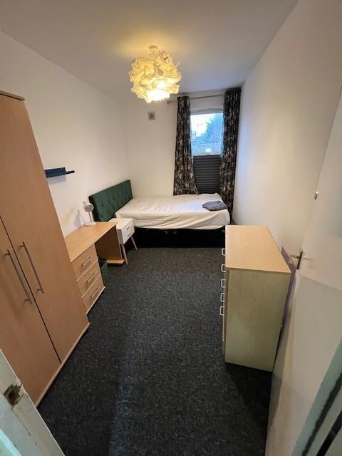 Neat single bedroom with a fitted wardrobe, bed...